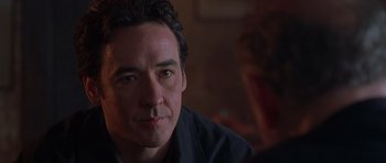 Movie still from “Runaway Jury” (2003), directed by Gary Fleder – A person sitting in a room; Close Up shot, Over the shoulder angle