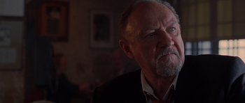 Movie still from “Runaway Jury” (2003), directed by Gary Fleder – An older man in a suit and tie looking to his left; Close Up shot, Low angle