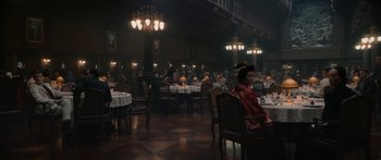 Movie still from “1899” (2022), created by Jantje Friese – People are sitting at tables in a large room; Wide shot, High angle