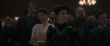 Movie still from “1899” (2022), created by Jantje Friese – A group of people standing in front of a wall; Medium shot, Over the shoulder angle