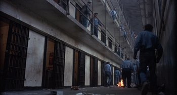 Movie still from “Runaway Train” (1985), directed by Andrey Konchalovskiy – A group of people standing outside of a jail cell; Extreme Wide shot, High angle