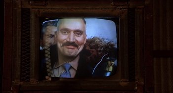 Movie still from “Runaway Train” (1985), directed by Andrey Konchalovskiy – An old television screen showing a man with a mustache; Extreme Close Up shot, Over the shoulder angle