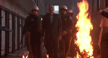Movie still from “Runaway Train” (1985), directed by Andrey Konchalovskiy – A group of men standing next to a burning fire; Wide shot, Low angle