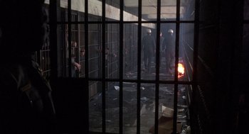 Movie still from “Runaway Train” (1985), directed by Andrey Konchalovskiy – A group of people standing in a jail cell; Wide shot, High angle