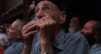 Movie still from “Runaway Train” (1985), directed by Andrey Konchalovskiy – An old man is eating something while sitting in a chair; Close Up shot, High angle