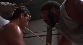 Movie still from “Runaway Train” (1985), directed by Andrey Konchalovskiy – Two men in a boxing ring facing each other with ropes; Close Up shot, Low angle