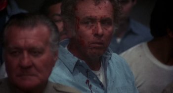 Movie still from “Runaway Train” (1985), directed by Andrey Konchalovskiy – A person with blood all over his face; Close Up shot, High angle