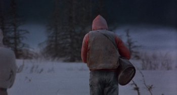Movie still from “Runaway Train” (1985), directed by Andrey Konchalovskiy – A person in a red jacket carrying a drum; Wide shot, Low angle