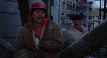 Movie still from “Runaway Train” (1985), directed by Andrey Konchalovskiy – A man with a red hat and a man with a brown jacket; Medium shot, Low angle