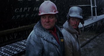 Movie still from “Runaway Train” (1985), directed by Andrey Konchalovskiy – Two men wearing hard hats in the snow; Medium shot, High angle