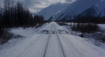Movie still from “Runaway Train” (1985), directed by Andrey Konchalovskiy – A train track in the middle of a snow covered field; Extreme Wide shot, High angle