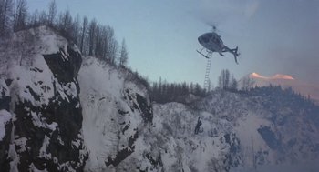 Movie still from “Runaway Train” (1985), directed by Andrey Konchalovskiy – A helicopter is flying over a mountain with a ladder; Extreme Wide shot, High angle