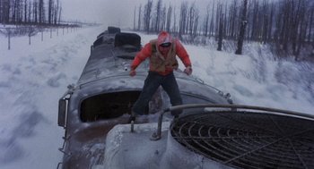 Movie still from “Runaway Train” (1985), directed by Andrey Konchalovskiy – A man standing on top of an old train; Wide shot, High angle