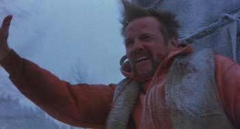 Movie still from “Runaway Train” (1985), directed by Andrey Konchalovskiy – A man with a beard is smiling for the camera; Close Up shot, Low angle