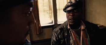 Movie still from “Running Scared” (2006), directed by Wayne Kramer – A man wearing a leather jacket and a hat; Close Up shot, Over the shoulder angle