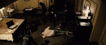 Movie still from “Running Scared” (2006), directed by Wayne Kramer – A group of people are laying on the floor; Wide shot, High angle