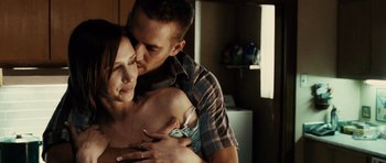 Movie still from “Running Scared” (2006), directed by Wayne Kramer – A man and a woman kissing in a kitchen; Close Up shot, Over the shoulder angle