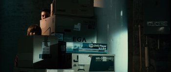 Movie still from “Running Scared” (2006), directed by Wayne Kramer – Boxes stacked on top of each other in a room; Extreme Close Up shot, High angle