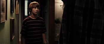 Movie still from “Running Scared” (2006), directed by Wayne Kramer – A young man standing in front of a mirror; Medium shot, Over the shoulder angle