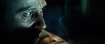 Movie still from “Running Scared” (2006), directed by Wayne Kramer – A man smoking a cigarette in the dark; Extreme Close Up shot, Over the shoulder angle