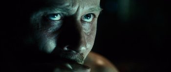 Movie still from “Running Scared” (2006), directed by Wayne Kramer – A man's face with blue eyes; Close Up shot, Over the shoulder angle