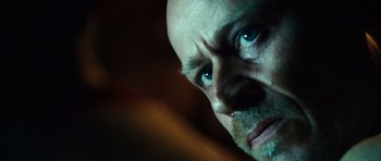 Movie still from “Running Scared” (2006), directed by Wayne Kramer – A person's face with blue eyes; Extreme Close Up shot, Low angle