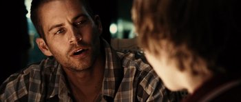 Movie still from “Running Scared” (2006), directed by Wayne Kramer – A man in a checkered shirt talking to another man in a checkered shirt; Close Up shot, Over the shoulder angle