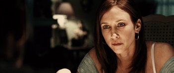 Movie still from “Running Scared” (2006), directed by Wayne Kramer – A person sitting in a room; Close Up shot, Over the shoulder angle