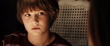 Movie still from “Running Scared” (2006), directed by Wayne Kramer – A young boy is looking into the distance; Close Up shot, High angle