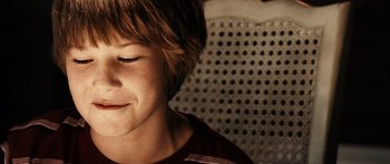 Movie still from “Running Scared” (2006), directed by Wayne Kramer – A person with his eyes closed; Close Up shot, High angle