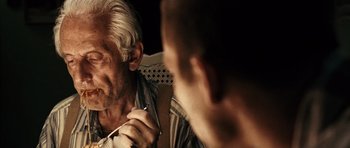 Movie still from “Running Scared” (2006), directed by Wayne Kramer – An older man looking at a younger man in the mirror; Close Up shot, Over the shoulder angle