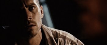 Movie still from “Running Scared” (2006), directed by Wayne Kramer – A man's face in a dark room; Close Up shot, Over the shoulder angle