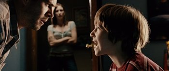 Movie still from “Running Scared” (2006), directed by Wayne Kramer – A young boy and a woman looking at each other in front of a mirror; Medium shot, Over the shoulder angle