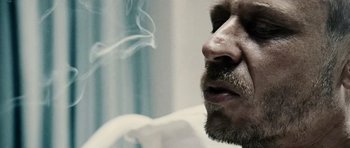 Movie still from “Running Scared” (2006), directed by Wayne Kramer – A person smoking a cigarette; Extreme Close Up shot, Low angle