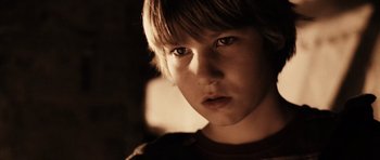 Movie still from “Running Scared” (2006), directed by Wayne Kramer – A young boy is looking into the camera; Close Up shot, Low angle