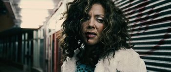 Movie still from “Running Scared” (2006), directed by Wayne Kramer – A person with curly hair; Close Up shot, Overhead angle