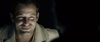 Movie still from “Running Scared” (2006), directed by Wayne Kramer – A person wearing a jacket; Close Up shot, Over the shoulder angle