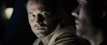 Movie still from “Running Scared” (2006), directed by Wayne Kramer – A person looking at the camera; Close Up shot, Over the shoulder angle