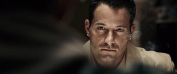 Movie still from “Running Scared” (2006), directed by Wayne Kramer – A person wearing a shirt; Close Up shot, Over the shoulder angle