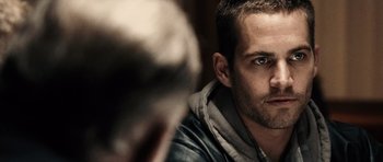 Movie still from “Running Scared” (2006), directed by Wayne Kramer – A person looking at the camera; Close Up shot, Over the shoulder angle