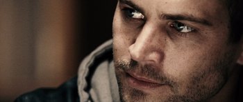 Movie still from “Running Scared” (2006), directed by Wayne Kramer – A man with a beard looking to his left; Extreme Close Up shot, Over the shoulder angle