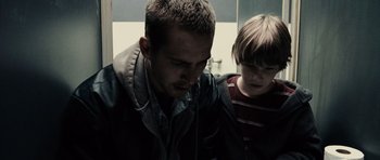 Movie still from “Running Scared” (2006), directed by Wayne Kramer – A man and a boy looking at each other; Close Up shot, Over the shoulder angle