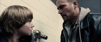 Movie still from “Running Scared” (2006), directed by Wayne Kramer – A man and a boy are standing in front of a mirror; Close Up shot, Over the shoulder angle