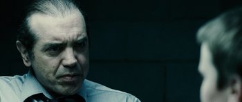 Movie still from “Running Scared” (2006), directed by Wayne Kramer – A person wearing a shirt and a tie; Close Up shot, Over the shoulder angle