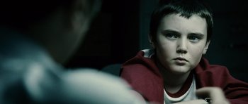 Movie still from “Running Scared” (2006), directed by Wayne Kramer – A young man sitting in front of a mirror; Close Up shot, Over the shoulder angle