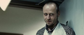 Movie still from “Running Scared” (2006), directed by Wayne Kramer – A person wearing a tie; Close Up shot, Low angle