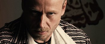 Movie still from “Running Scared” (2006), directed by Wayne Kramer – A person wearing a shirt and tie; Close Up shot, Low angle