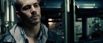 Movie still from “Running Scared” (2006), directed by Wayne Kramer – A person wearing a jacket; Close Up shot, Over the shoulder angle