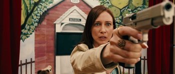 Movie still from “Running Scared” (2006), directed by Wayne Kramer – A woman holding a gun in front of a school building; Close Up shot, High angle