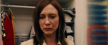 Movie still from “Running Scared” (2006), directed by Wayne Kramer – A person wearing a dress shirt; Close Up shot, Over the shoulder angle